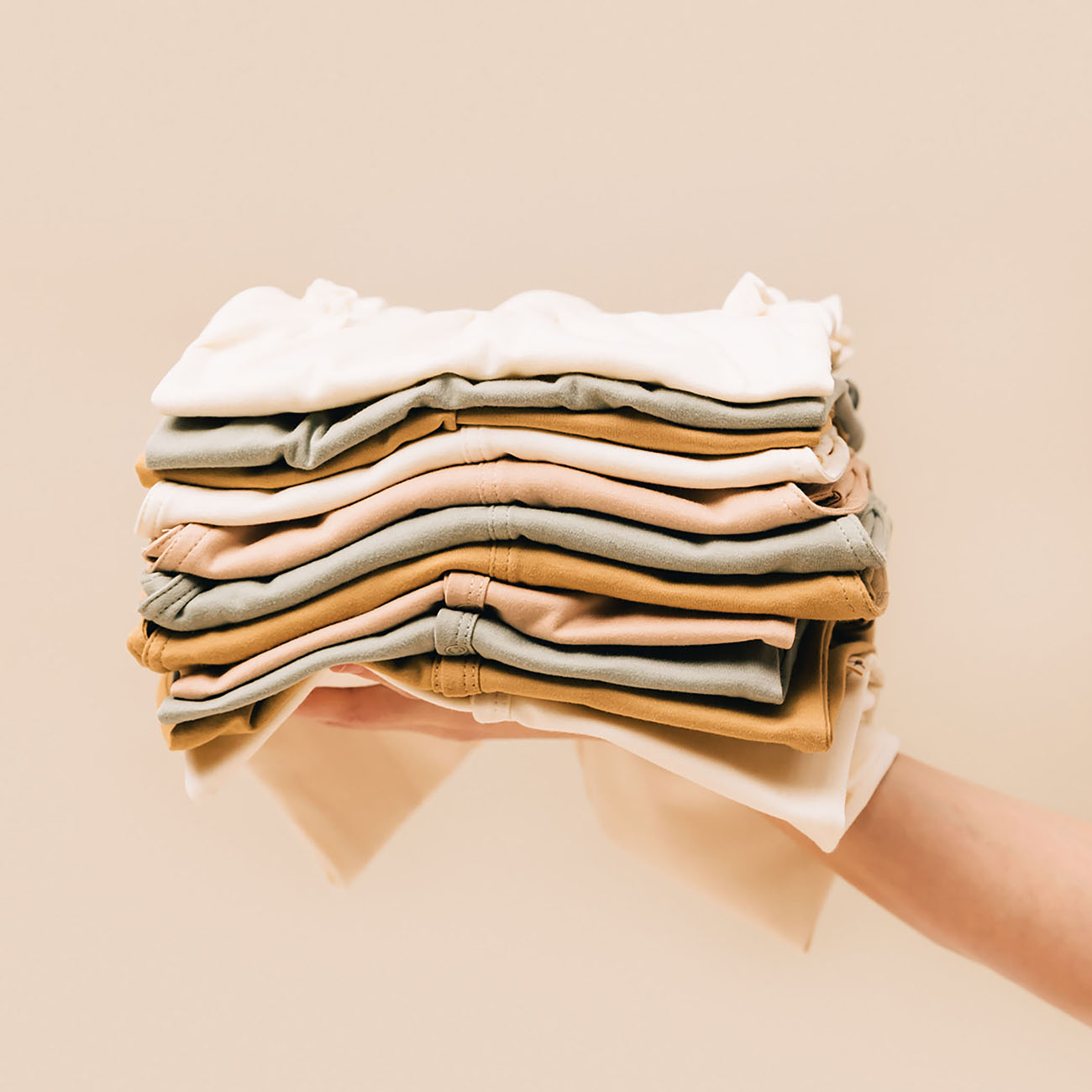 Pile of baby clothing in pima cotton | UAUA Collections