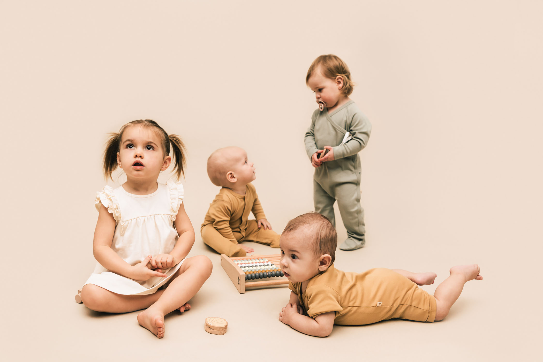 Babies and toddlers wearing clothing of UAUA Collections