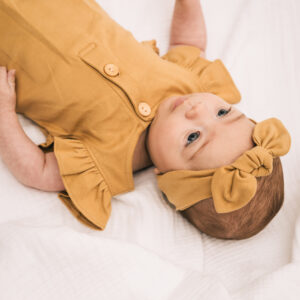 Baby wearing outfit and ribbon in pima cotton | UAUA Collections