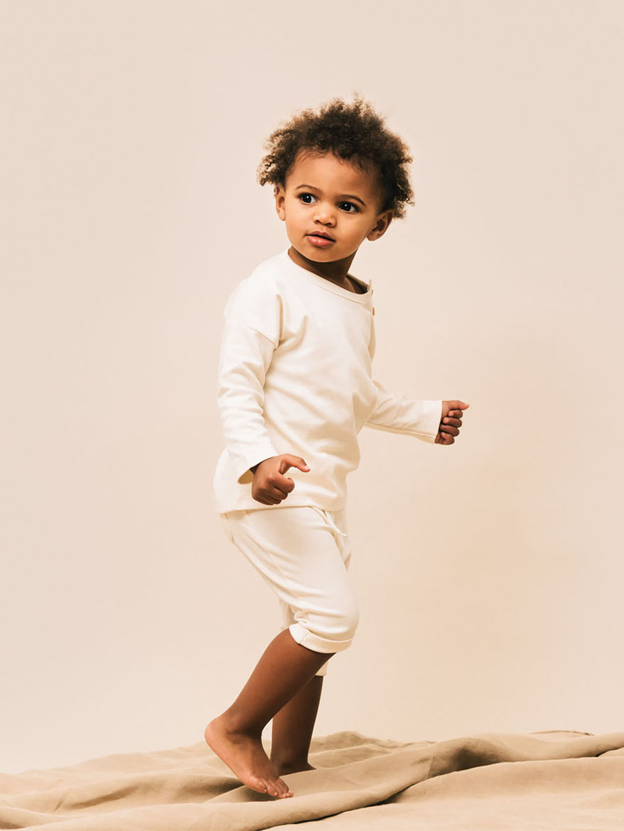 Toddler wearing white outfit in pima cotton | UAUA Collections