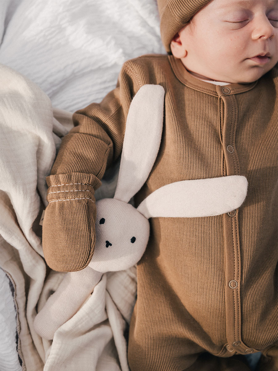 baby wearing chocolate onesie in pima cotton | UAUA Collections