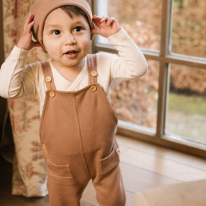 Toddler wearing overall and hat in pima cotton - biscotti - Puno Collection | UAUA Collections